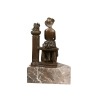 Bronze statue of a woman sitting on a balustrade - 