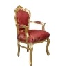 Golden baroque armchair and rococo red fabric -