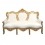 Valkoinen barokki sohva ja kultaisesta puusta